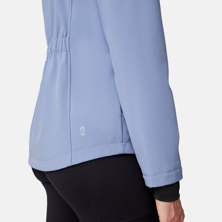 [Emily is 5'9" wearing size S.] Women’s light blue softshell hooded jacket with black zippers, sleeve pocket, and front zip closure — lightweight, weather-resistant layer for active wear