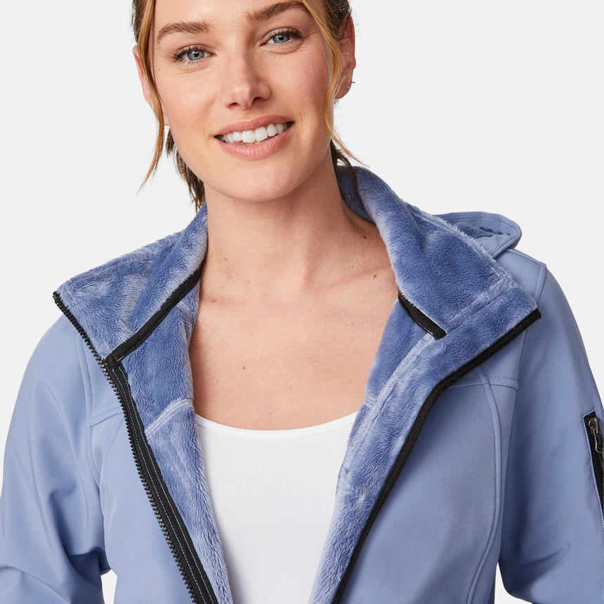 [Emily is 5'9" wearing size S.] Women’s light blue softshell hooded jacket with black zippers, sleeve pocket, and front zip closure — lightweight, weather-resistant layer for active wear