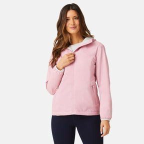 A woman with long brown hair smiles at the camera in a light pink Women's Windshear Jacket by Clearance, paired with dark pants and posed against a plain white background.