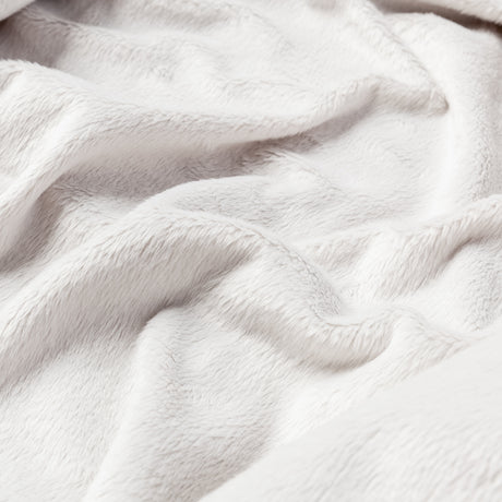 The Clearance Women's Windshear Jacket features soft, white, fluffy fabric with gentle folds and creases, creating a cozy feel that's both inviting and subtly wind resistant.
