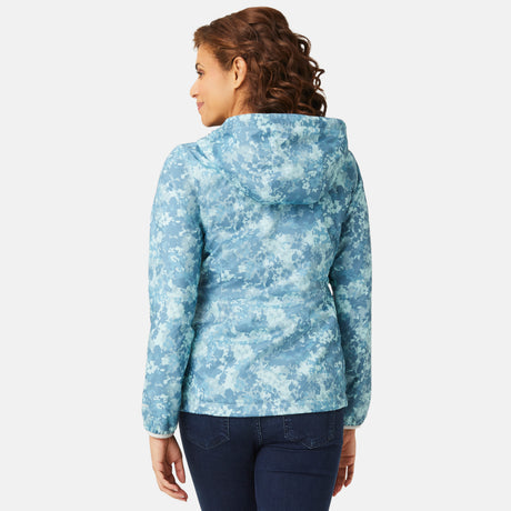 A woman with curly brown hair, seen from behind, wears the Clearance Women's Windshear Jacket—a blue and white patterned, water-resistant, stylish piece—paired with dark jeans against a plain white background.