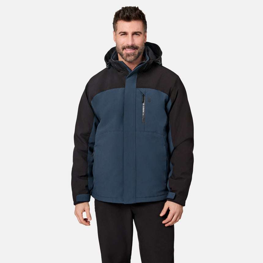 [Model is wearing size M.] A man wearing a two-tone hooded jacket in navy blue and black, paired with black pants, standing against a light gray studio background.