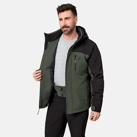[Model is wearing size M.] A man wearing a dark green and black outdoor jacket over a gray t-shirt and black pants, standing against a light gray studio background.