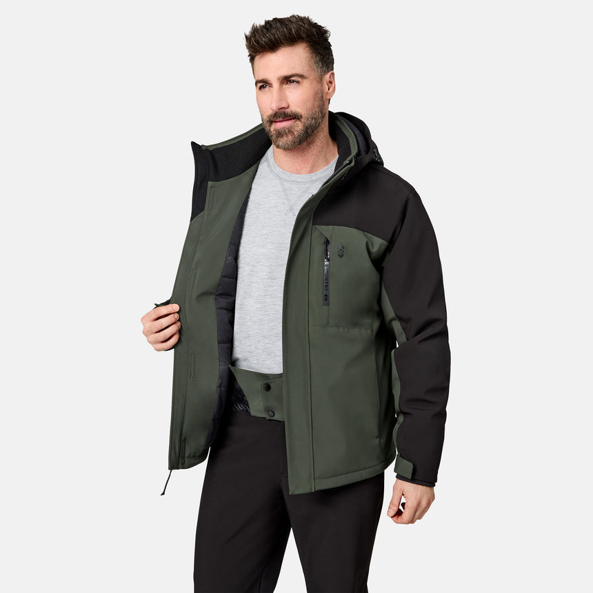 [Model is wearing size M.] A man wearing a dark green and black outdoor jacket over a gray t-shirt and black pants, standing against a light gray studio background.