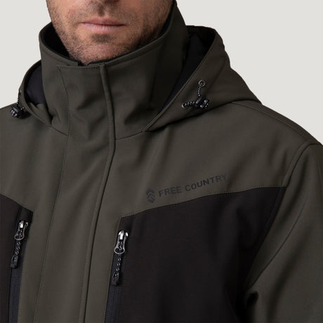 A man wears the Men's Thermo Softshell® Mid Weight Jacket by Clearance in olive green and black, featuring zippered pockets and the brand logo on the chest, shown shoulders up against a plain background.