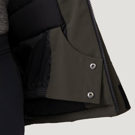 Close-up of the interior of the Men's Thermo Softshell® Mid Weight Jacket by Clearance, showing a snap button pocket, black lining, and part of a zipper. The open jacket reveals wind-resistant fabric and textured materials.