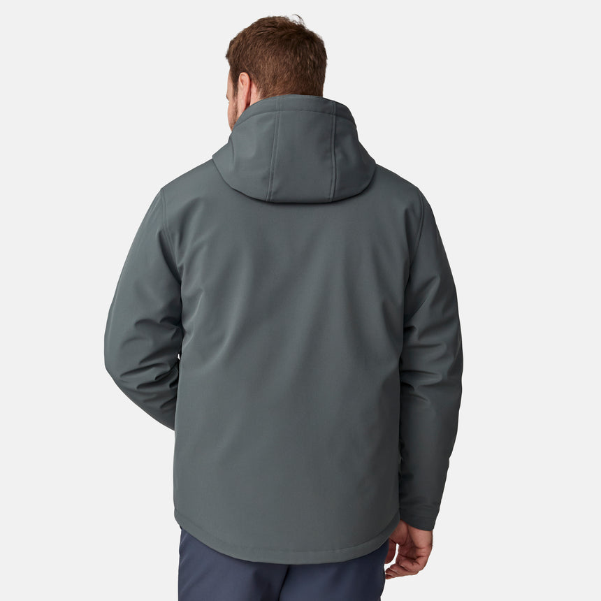 [Joe is 6'0" wearing size M.] Men’s Free Country two-tone hooded zip-front jacket with dark gray body and black paneling across shoulders and chest—features dual vertical zippered chest pockets, side hand pockets, full-length front zipper, and an attached interior snow skirt for enhanced protection against the elements. Paired with matching gray pants for a sleek, coordinated winter look.