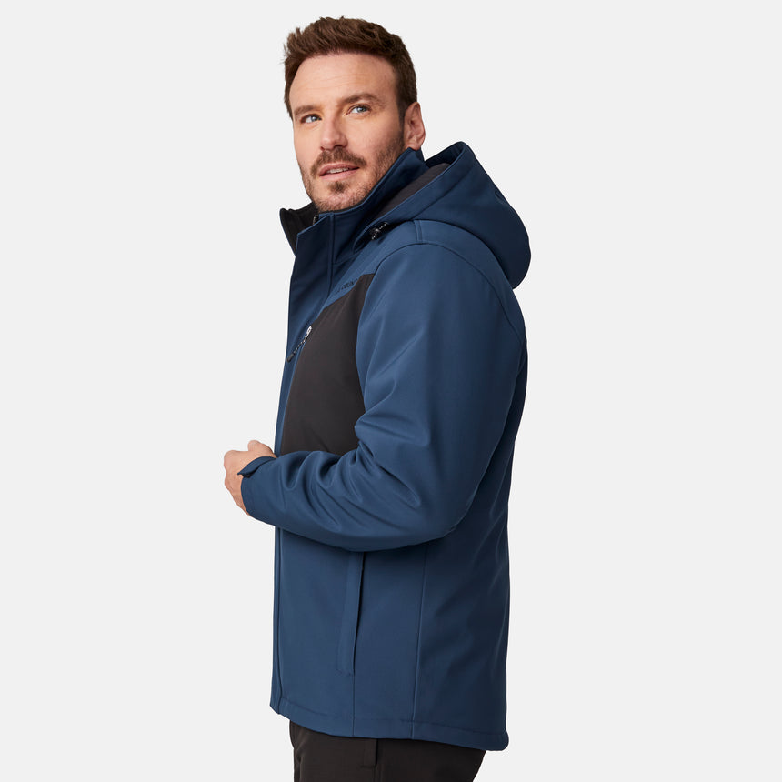 [Joe is 6'0" wearing size M.]  "Men’s Free Country hooded zip-front jacket with black chest panels and deep blue sleeves and body—features dual vertical zippered chest pockets, side hand pockets, full-length zipper closure, and an attached interior snow skirt for added protection against snow and wind. Styled with black pants for a sleek, functional cold-weather look.