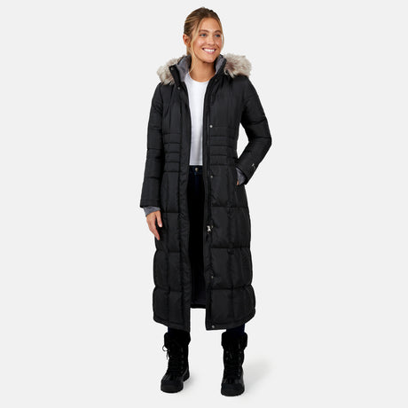 [Brooke is 5'9" wearing a size Small.] Woman wearing Free Country Women's Full Length Splendor Down Jacket in black with a full front zipper opening, lower pockets, calf length, a detachable hood with faux fur trim, and water resistant and wind resistant stretch performance fabric, light grey background. Best women’s jacket for winter weather.