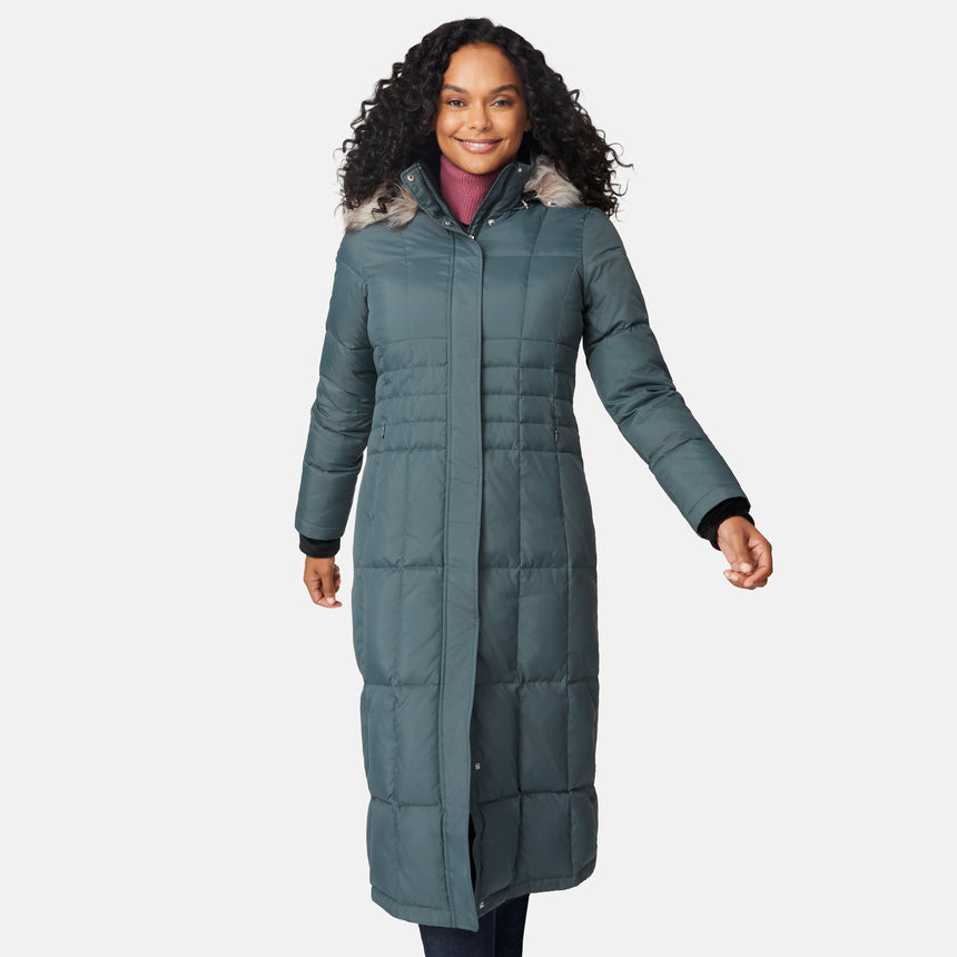 [Angelique is 5'10" wearing size S.] Woman wearing Free Country Women's Full Length Splendor Down Jacket in green with a full front zipper opening, lower pockets, calf length, a detachable hood with faux fur trim, and water resistant and wind resistant stretch performance fabric, light grey background. Best women’s jacket for winter weather.