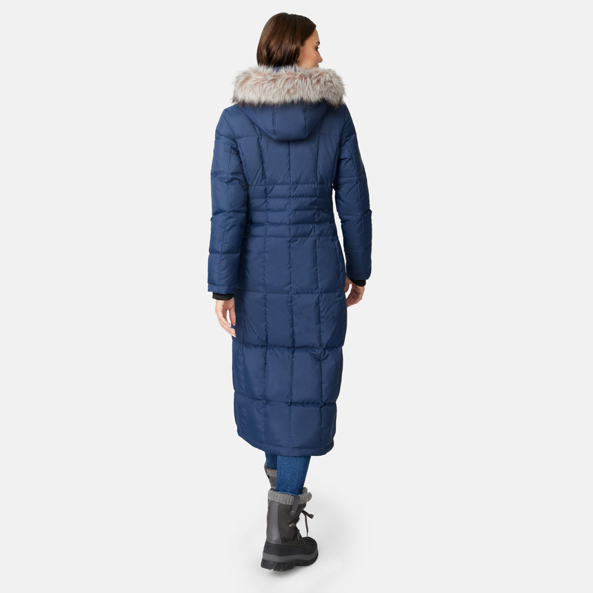 [Jessica is 5'9.5" wearing size S.] Woman wearing Free Country Women's Full Length Splendor Down Jacket in navy blue with a full front zipper opening, lower pockets, calf length, a detachable hood with faux fur trim, and water resistant and wind resistant stretch performance fabric, light grey background. Best women’s jacket for winter weather.
