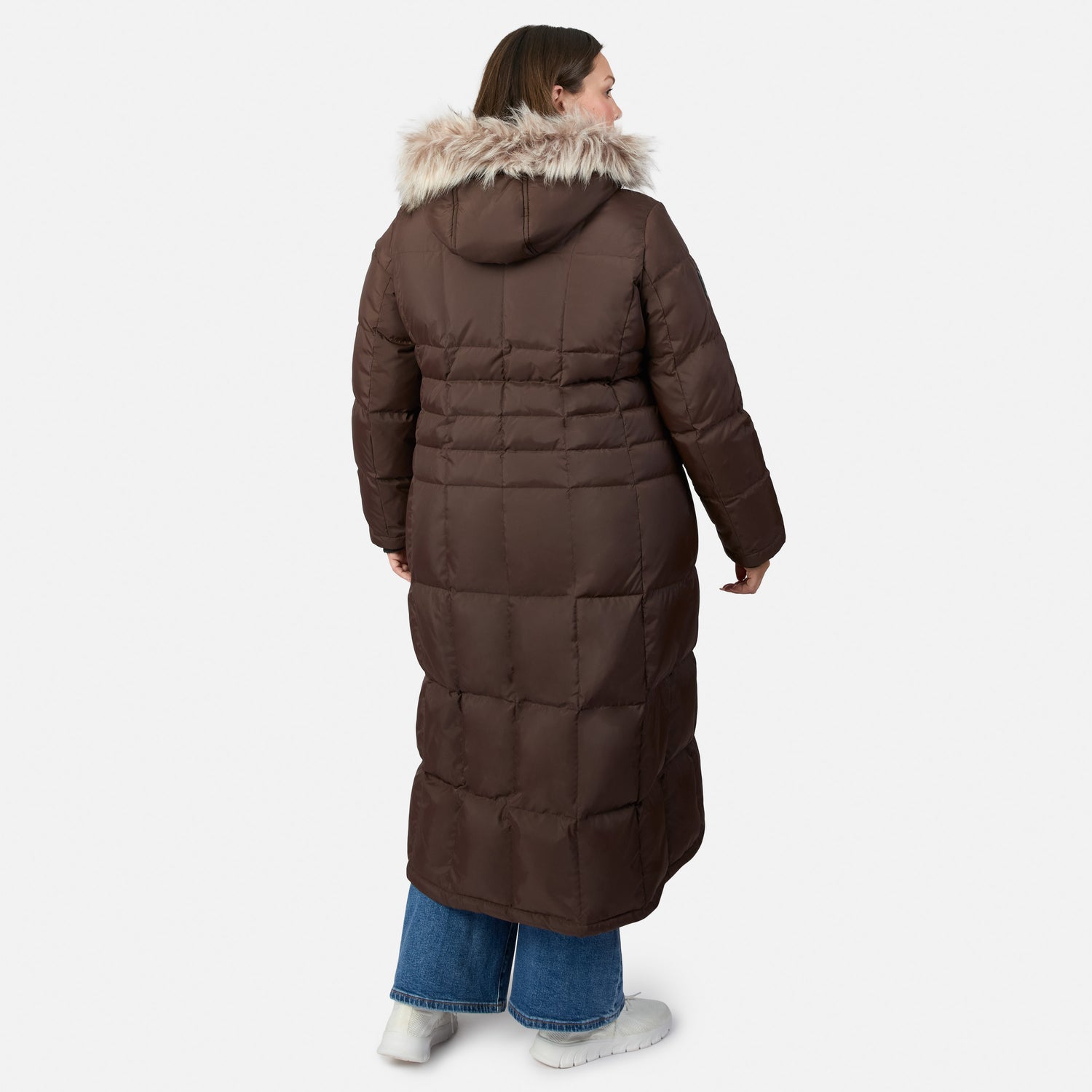 Back view of a woman in a burgundy full length Splendor down jacket with a fur trimmed hood