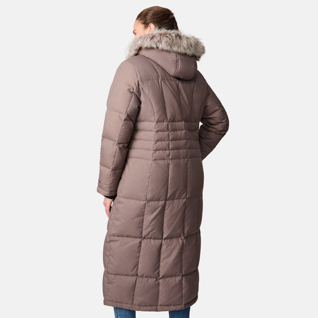 A woman is seen from behind wearing the Free Country Women's Plus Size Full Length Splendor Down Jacket in taupe, featuring a quilted design, faux fur-trimmed hood, and water-resistant fabric against a plain light background.