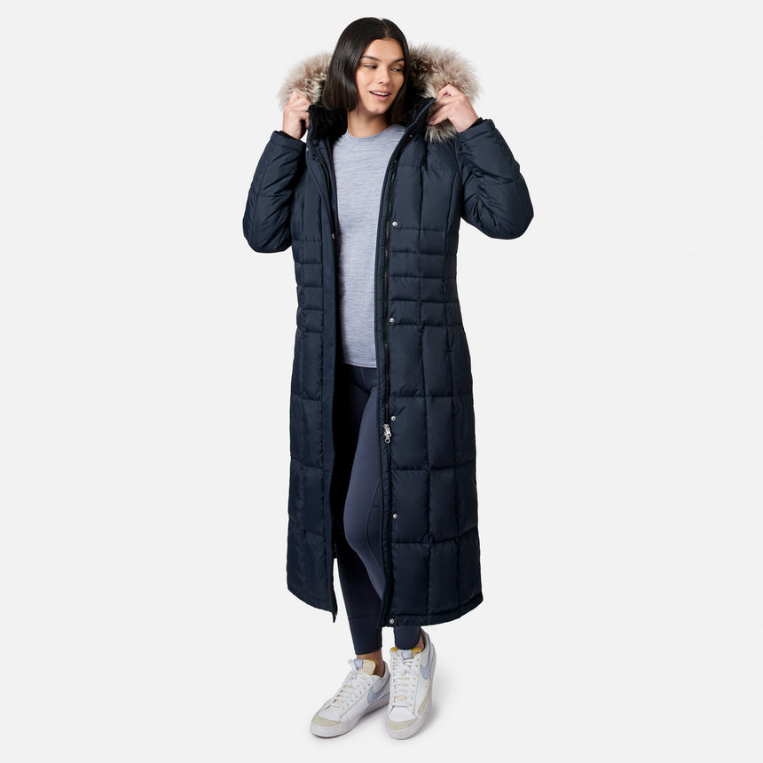 Model in navy Splendor Down Jacket with fur hood adjusting the hood.