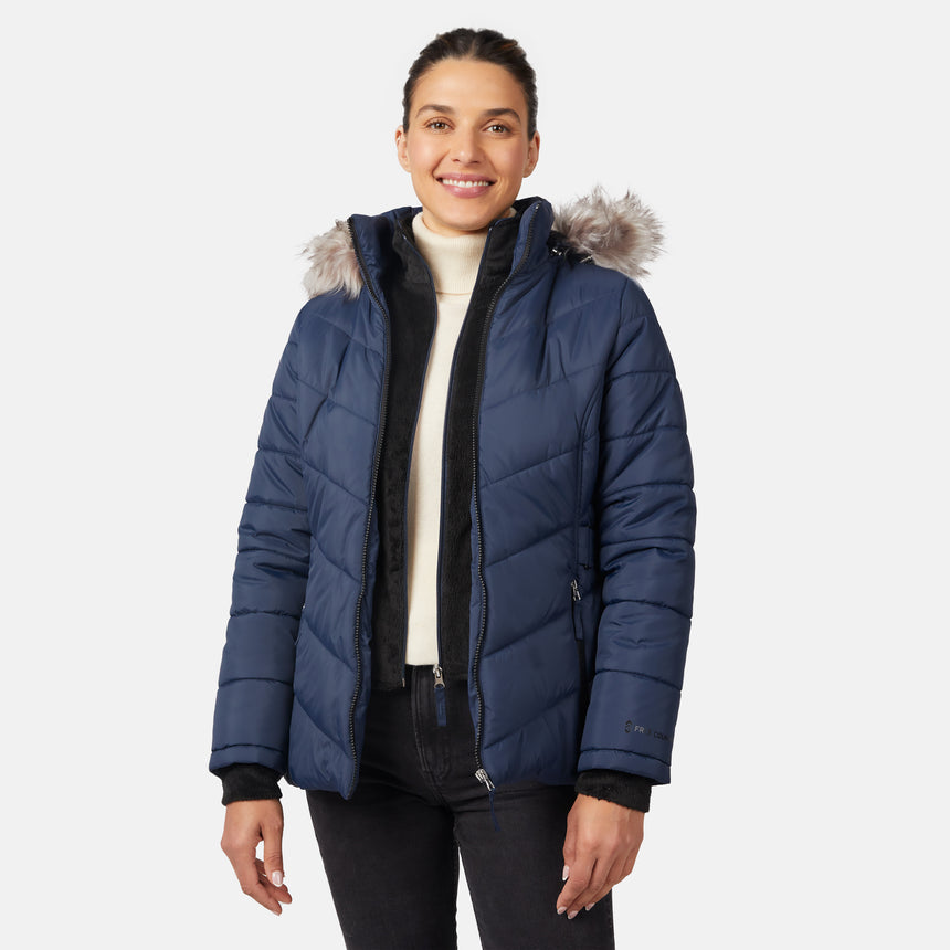[Olga is 5'9" wearing size S.] Model wearing blue quilted jacket with faux fur hood and attached bib — layered warmth and stylish silhouette for winter outings