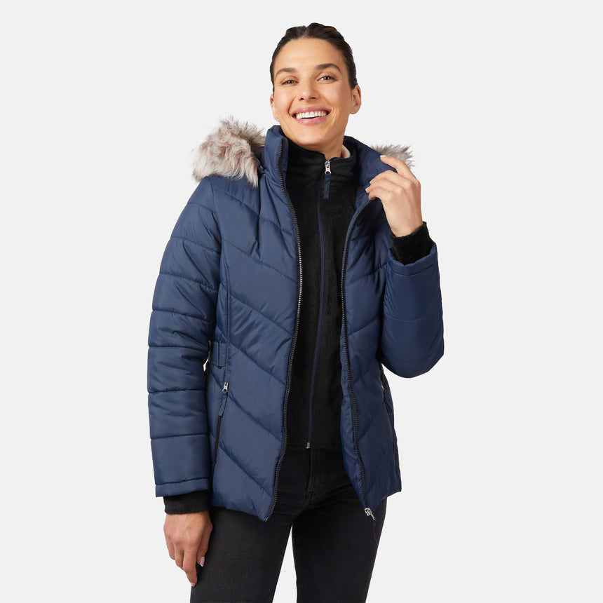 [Olga is 5'9" wearing size S.] Model wearing blue quilted jacket with faux fur hood and attached bib — layered warmth and stylish silhouette for winter outings