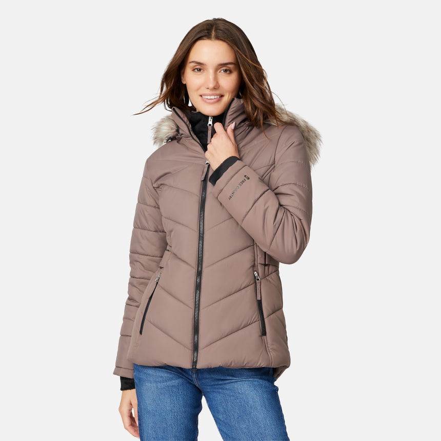 [Jessica is 5'9.5" wearing size S.] Model wearing brown quilted jacket with faux fur hood and attached bib — layered warmth and stylish silhouette for winter outings