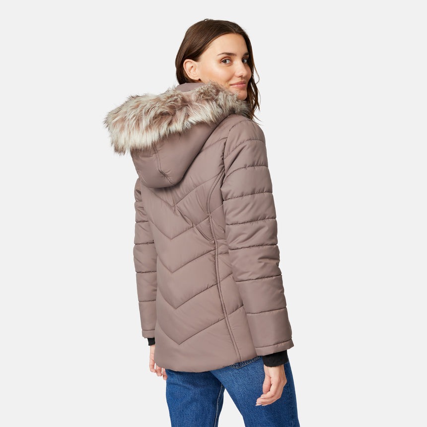 [Jessica is 5'9.5" wearing size S.] Model wearing brown quilted jacket with faux fur hood and attached bib — layered warmth and stylish silhouette for winter outings