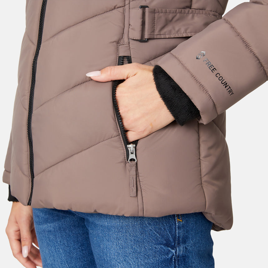 [Jessica is 5'9.5" wearing size S.] Model wearing brown quilted jacket with faux fur hood and attached bib — layered warmth and stylish silhouette for winter outings
