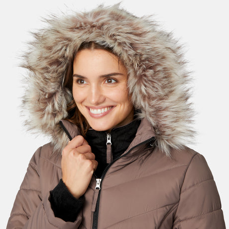[Jessica is 5'9.5" wearing size S.] Model wearing brown quilted jacket with faux fur hood and attached bib — layered warmth and stylish silhouette for winter outings