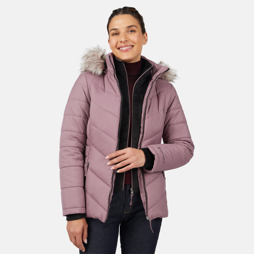 [Olga is 5'9" wearing size S.] Model wearing pink quilted jacket with faux fur hood and attached bib — layered warmth and stylish silhouette for winter outings