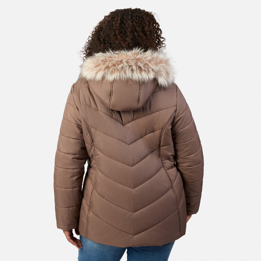 [Model is wearing size 1X] A person shown from the back wearing a brown puffer jacket with a fluffy light beige faux-fur trimmed hood, paired with blue jeans, against a light gray studio background.