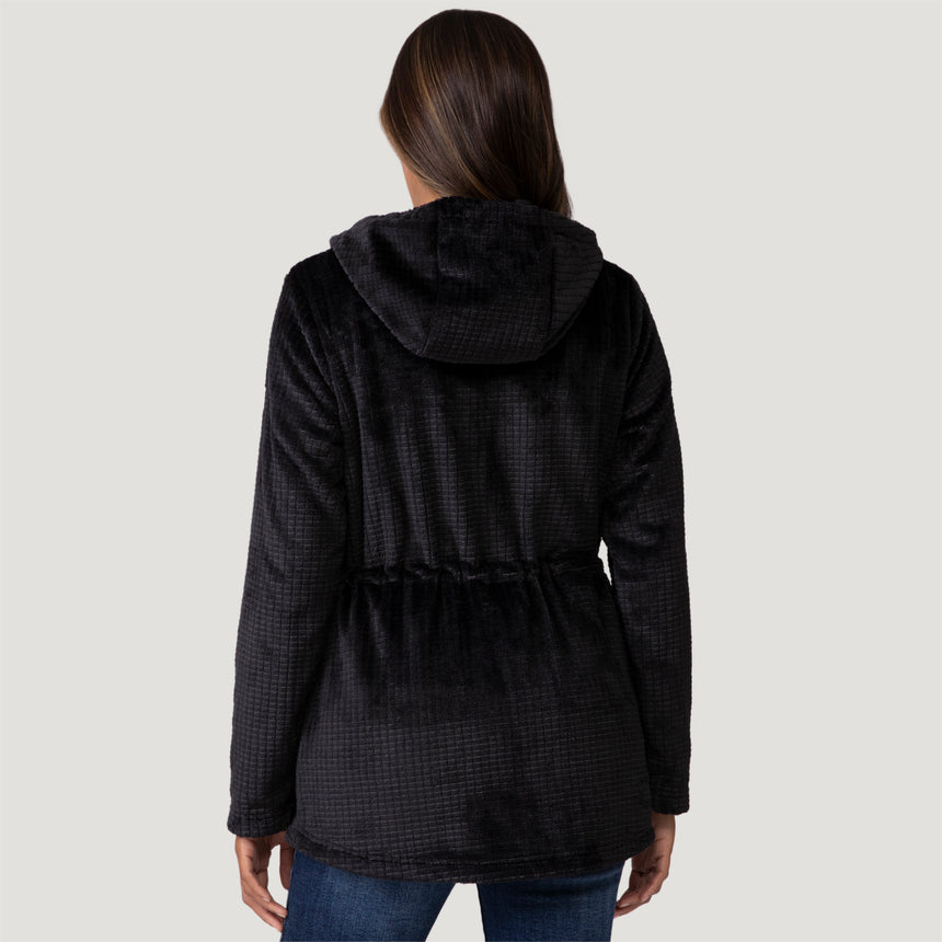 [Model is wearing size S.] Women’s Free Country black textured zip-front hooded jacket with wooden toggle drawstrings and dual side pockets—layered over a pink shirt and paired with blue jeans for a casual, cool-weather look.