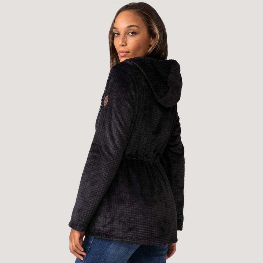 [Model is wearing size S.] Women’s Free Country black textured zip-front hooded jacket with wooden toggle drawstrings and dual side pockets—layered over a pink shirt and paired with blue jeans for a casual, cool-weather look.