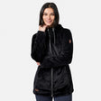 A woman with straight dark hair is smiling and posing with one hand near her neck, wearing the Free Country Women’s Grid Butter Pile® Anorak Jacket in black, against a plain light background.