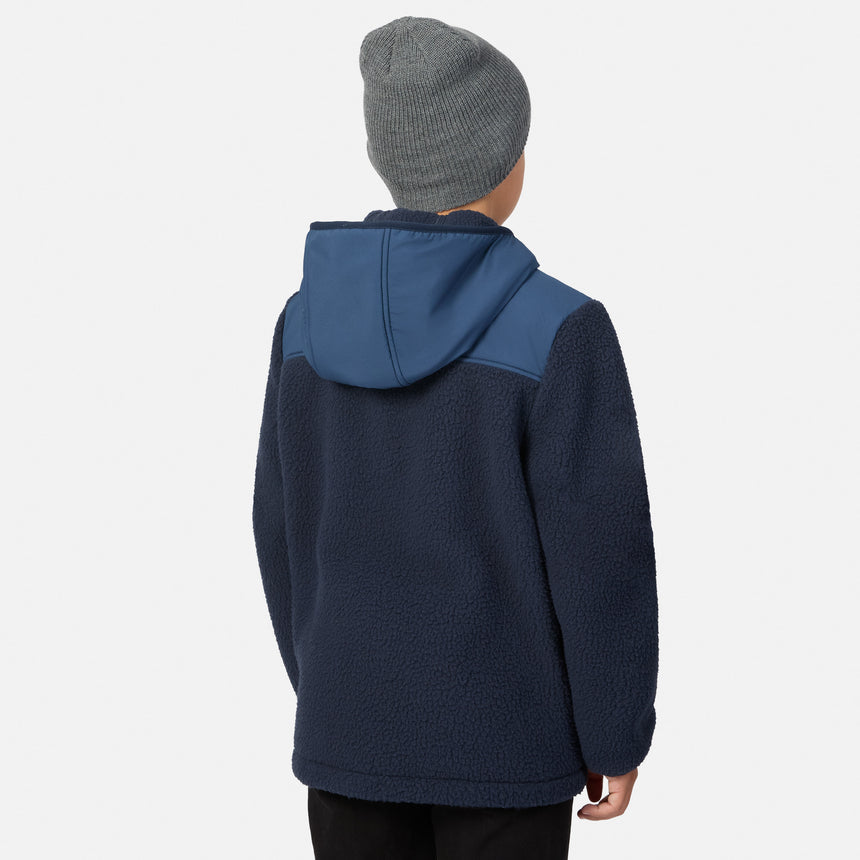 A child shown from the back wearing a navy fleece hooded jacket with a contrasting blue hood panel and a gray knit beanie, against a light gray studio background.