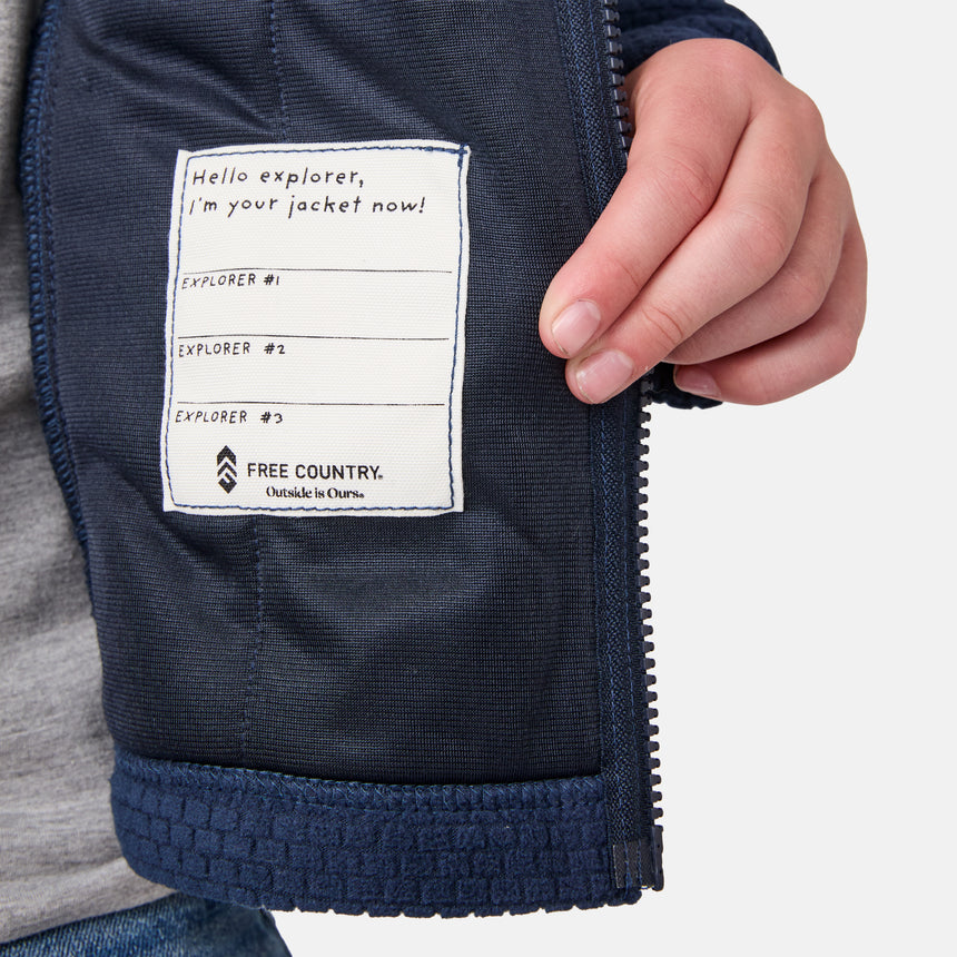 [River is wearing size M.] Navy jacket with a label on a light gray background