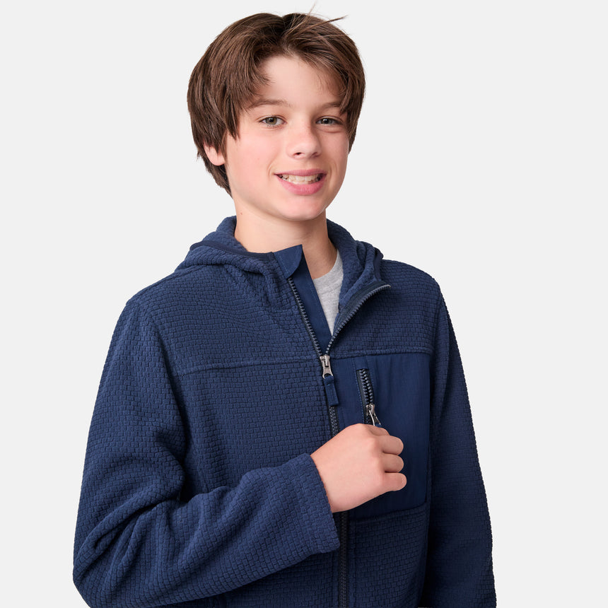 [River is wearing size M.] Child wearing a blue jacket on a white background