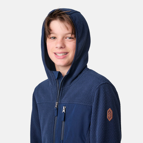 [River is wearing size M.] Child wearing a blue hoodie with a brand logo on a white background