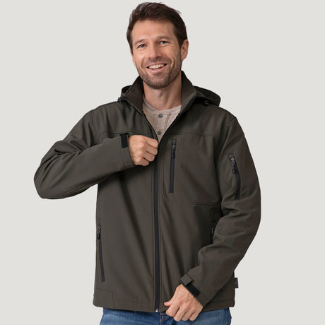 [Vince is 6'1" wearing a size Medium.] Man wearing Free Country Men's Odyssey II Flex Super Softshell® Jacket in dark green with a full front zipper opening, adjustable cuff openings, and wind and water resistant stretch performance fabric, light grey background. Perfect men’s jacket for fall weather.