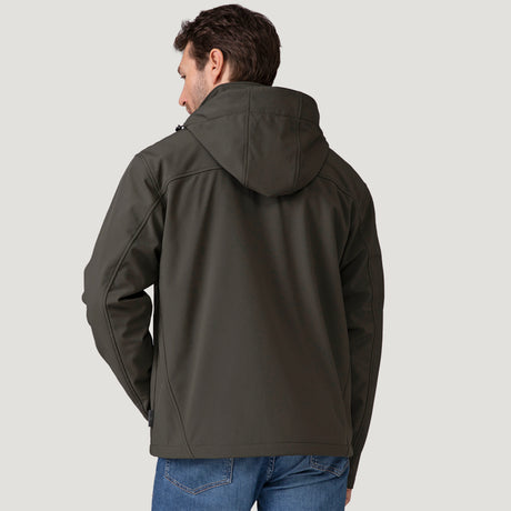 [Vince is 6'1" wearing a size Medium.] Man wearing Free Country Men's Odyssey II Flex Super Softshell® Jacket in dark green with a full front zipper opening, adjustable cuff openings, and wind and water resistant stretch performance fabric, light grey background. Perfect men’s jacket for fall weather.
