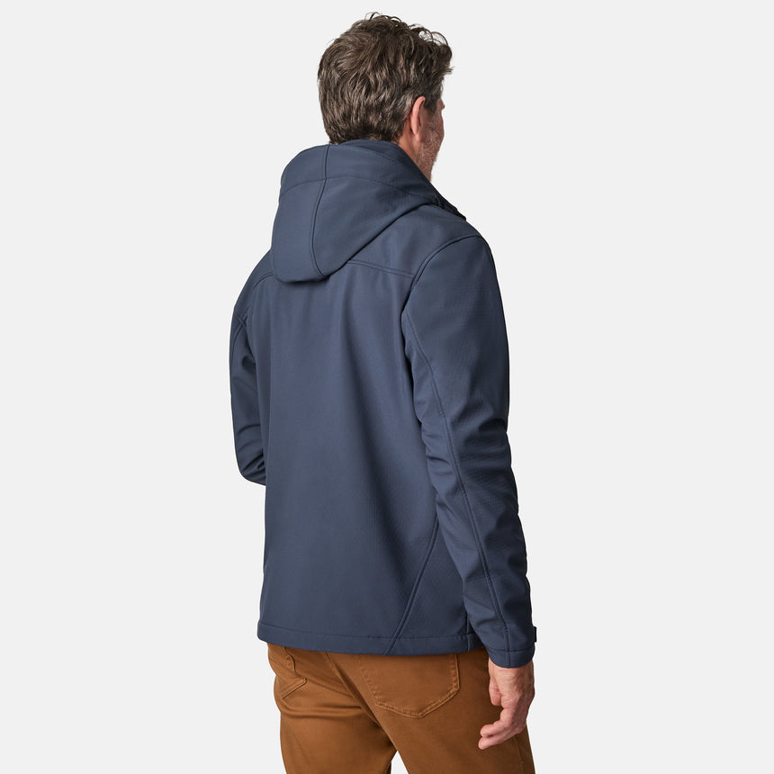 [Kolby is 6'2" wearing size M.] Man wearing Free Country Men's Odyssey II Flex Super Softshell® Jacket in blue with a full front zipper opening, adjustable cuff openings, and wind and water resistant stretch performance fabric, light grey background. Perfect men’s jacket for fall weather.