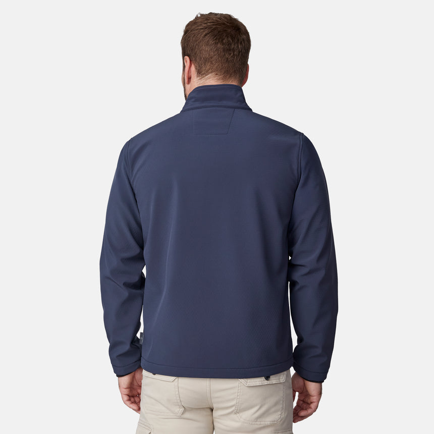 [Joe is 6'0" wearing size M.] Men’s Free Country navy blue zip-front softshell jacket with high stand collar, subtle chest logo, and minimalistic design—featuring streamlined silhouette and long sleeves. Worn with blue pants for a clean, versatile look suited to cool-weather outings.