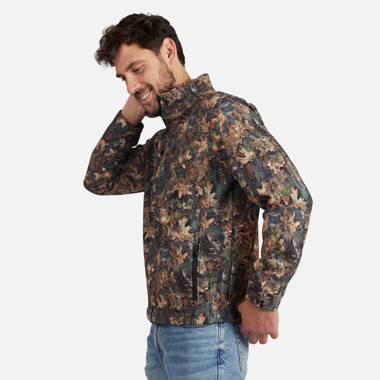 [Model is wearing size M.] A man wearing a camouflage leaf-print jacket and blue jeans, posing against a light gray background.