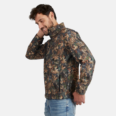 [Model is wearing size M.] A man wearing a camouflage leaf-print jacket and blue jeans, posing against a light gray background.