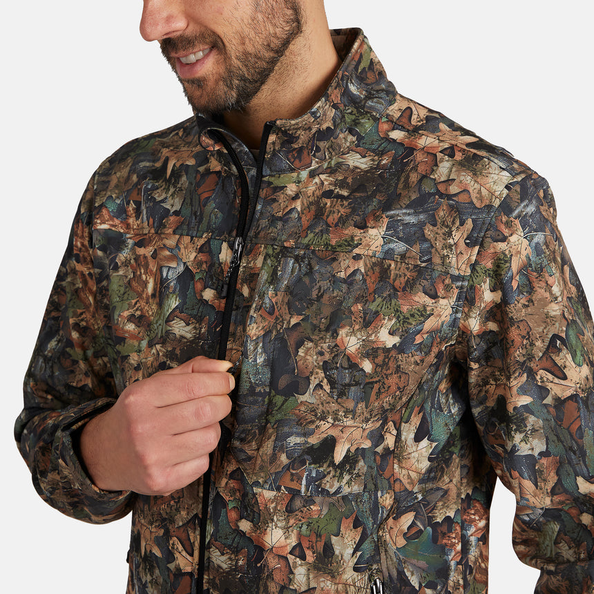 [Model is wearing size M.] A man wearing a camouflage jacket with a leaf pattern in shades of brown, green, and black, shown from the chest up against a light gray background.