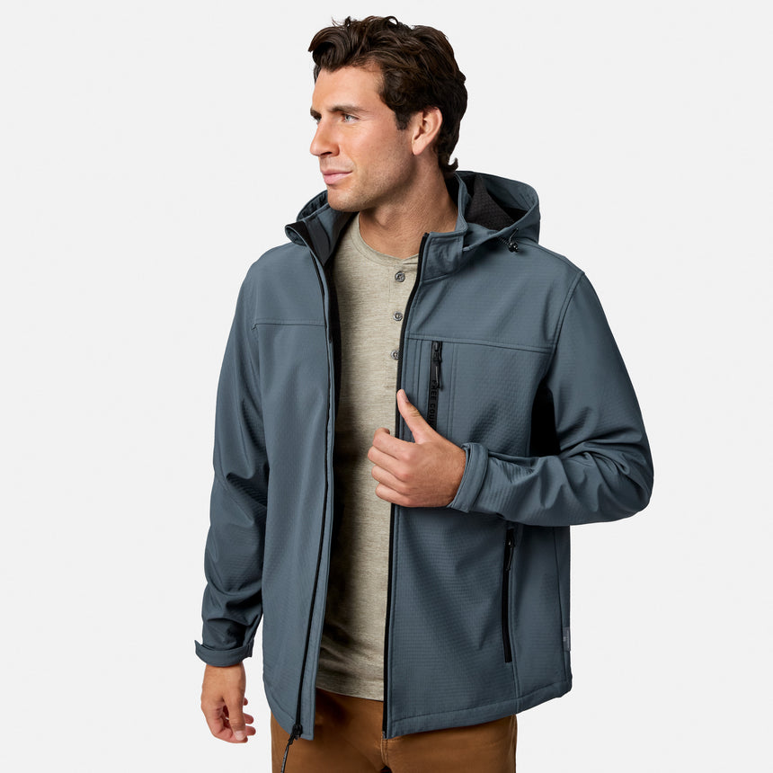 [Model is wearing size M.] A man wearing a slate blue-gray hooded softshell jacket over a light beige henley shirt, standing against a light gray studio background.