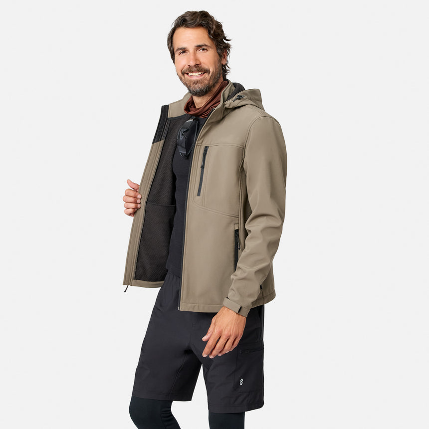 [Model is wearing size M.] A man wearing a light brown hooded jacket over a black shirt and black shorts, standing against a light gray background.