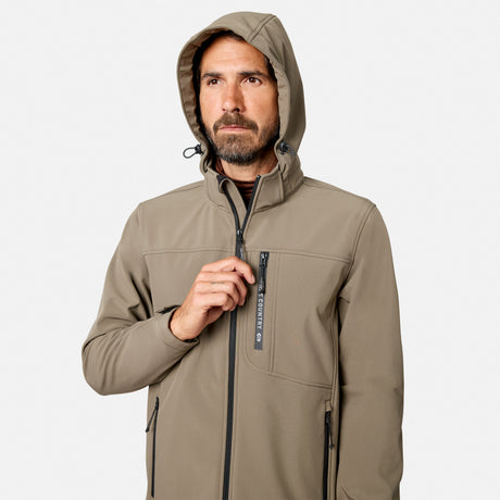 [Model is wearing size M.] A man wearing a hooded softshell jacket in a warm taupe-beige color, shown from the chest up against a light gray studio background. The jacket features a full front zipper, zippered chest pocket with a vertical black brand tab reading 'SCORPION', and black zipper pulls.