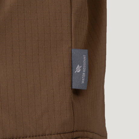 [Vince is 6’1” wearing size M.] Men’s Free Country brown hooded jacket with front zip closure and dual button-flap chest pockets. Worn over a charcoal tee and paired with blue jeans for a laid-back, utilitarian look that blends classic outerwear with everyday versatility.