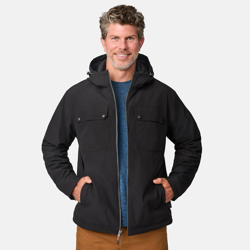 [Kolby is 6'2" wearing size M.] Men’s Free Country black hooded jacket with full-zip front, dual flap chest pockets, and button cuffs—featuring a clean silhouette and utility styling. Paired with brown pants for a rugged, cold-weather look that blends trail-ready function with everyday wearability.