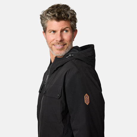 [Kolby is 6'2" wearing size M.] Men’s Free Country black hooded jacket with full-zip front, dual flap chest pockets, and button cuffs—featuring a clean silhouette and utility styling. Paired with brown pants for a rugged, cold-weather look that blends trail-ready function with everyday wearability.