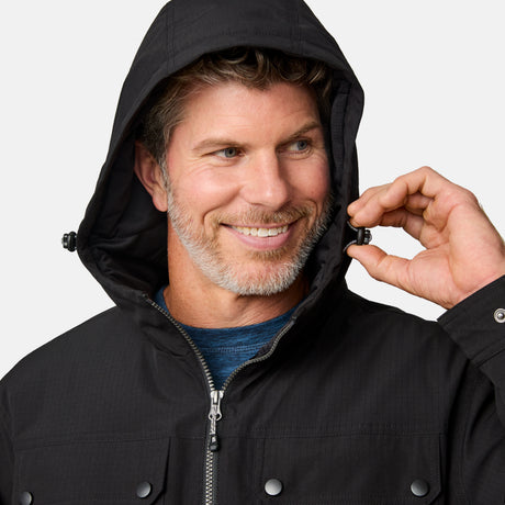 [Kolby is 6'2" wearing size M.] Men’s Free Country black hooded jacket with full-zip front, dual flap chest pockets, and button cuffs—featuring a clean silhouette and utility styling. Paired with brown pants for a rugged, cold-weather look that blends trail-ready function with everyday wearability.