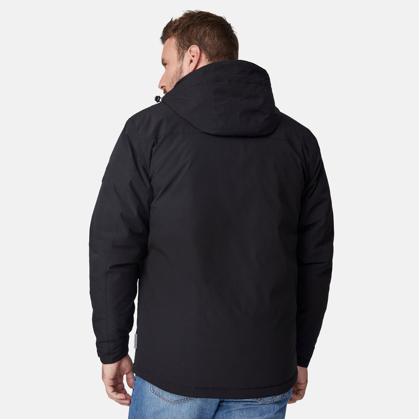 [Joe is 6'0" wearing size M.] Men’s Free Country black hooded utility jacket featuring dual zippered chest pockets, flap waist pockets, and rugged outdoor styling—paired with blue jeans for a functional, adventure-ready look.