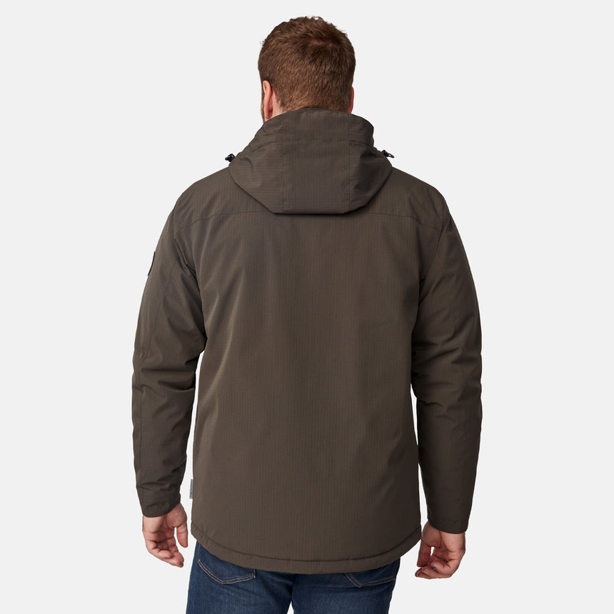 [Joe is 6'0" wearing size M.] Men’s Free Country brown hooded utility jacket featuring dual zippered chest pockets, flap waist pockets, and rugged outdoor styling—paired with blue jeans for a functional, adventure-ready look.