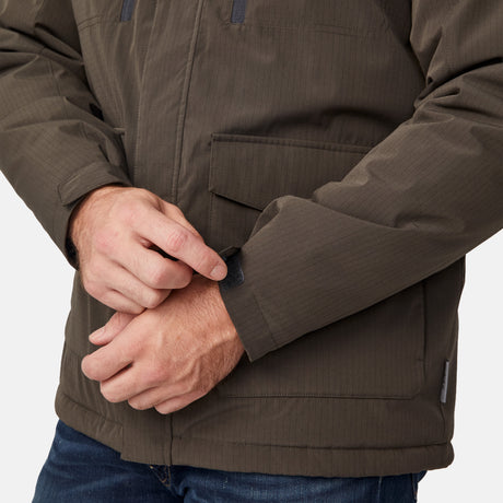 [Joe is 6'0" wearing size M.] Men’s Free Country brown hooded utility jacket featuring dual zippered chest pockets, flap waist pockets, and rugged outdoor styling—paired with blue jeans for a functional, adventure-ready look.